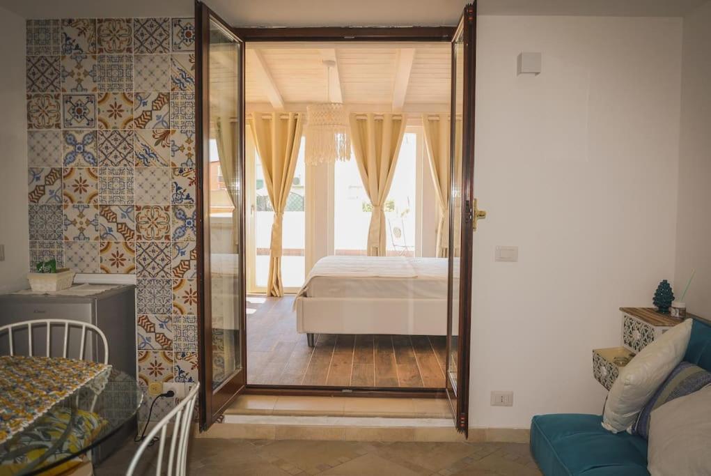 a bedroom with a bed and a large mirror at Il Mare a Roma - Attico Fronte Mare in Lido di Ostia
