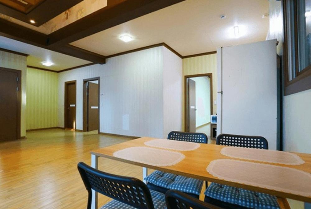 a conference room with a wooden table and chairs at Gapyeong hatteuneun supsok pension in Gapyeong