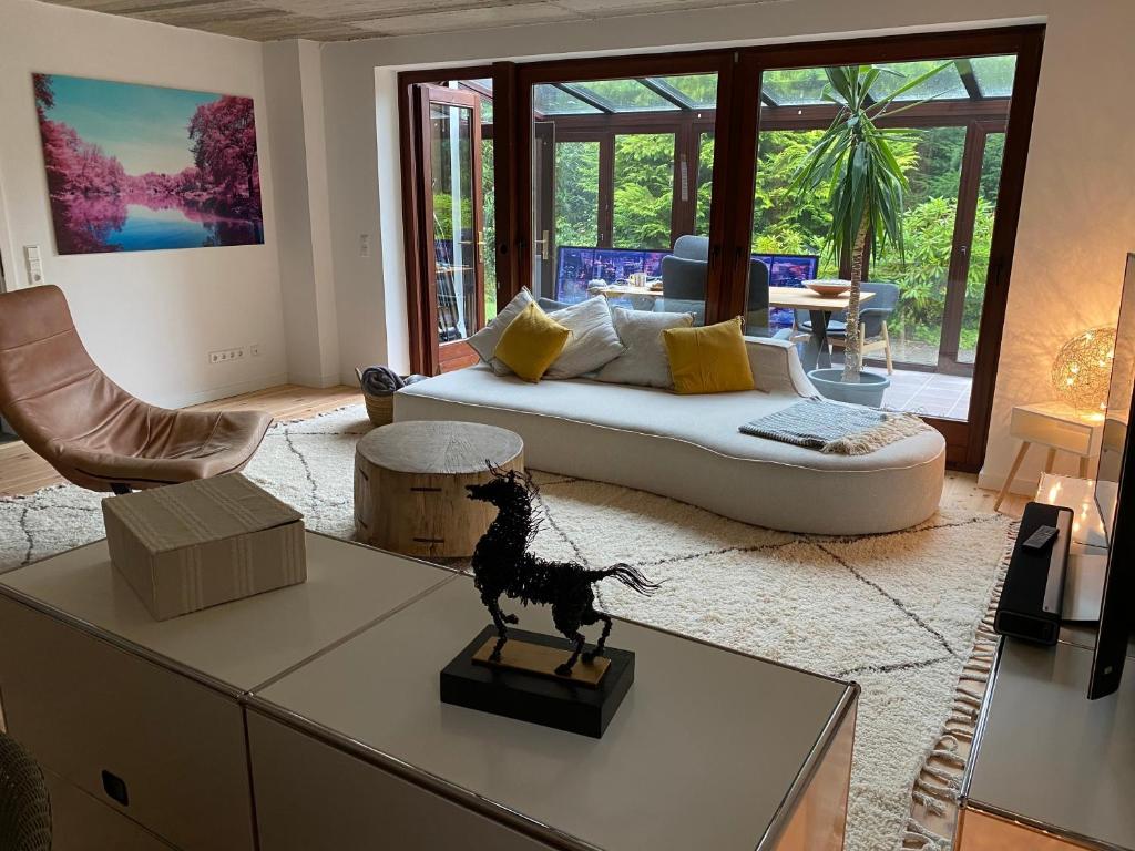 a living room with a couch and a dog on a table at Wohlfühloase in Windeby