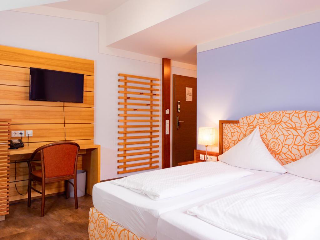 Postel nebo postele na pokoji v ubytování Hotel Geiger