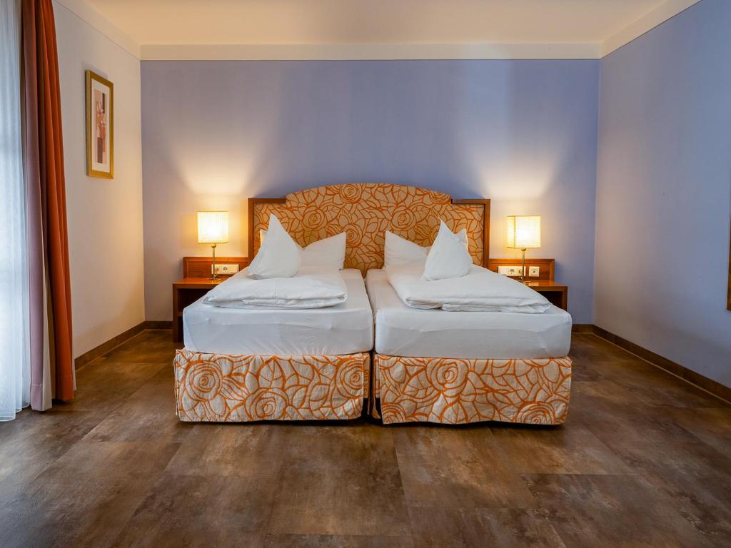 Postel nebo postele na pokoji v ubytování Hotel Geiger