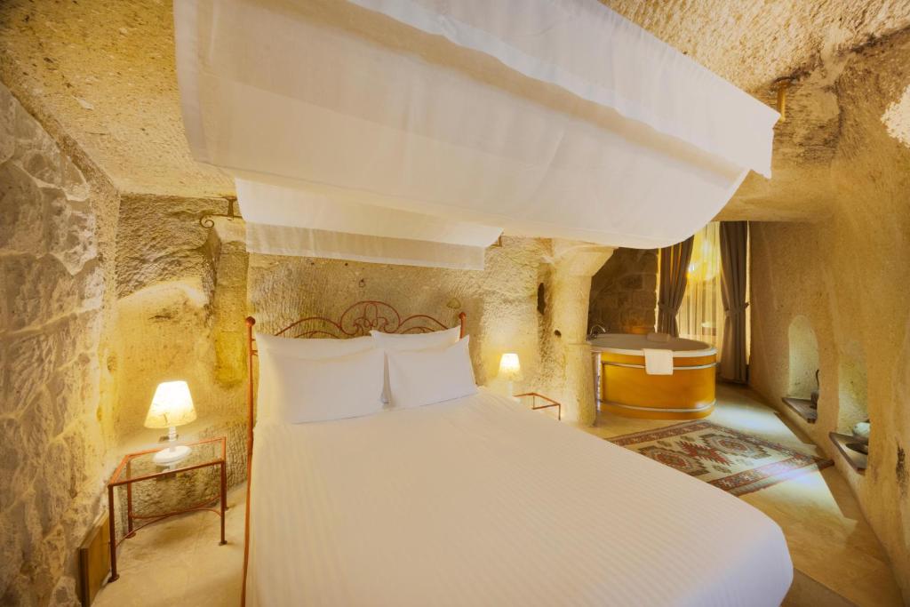 A bed or beds in a room at Tafoni Houses Cave Hotel
