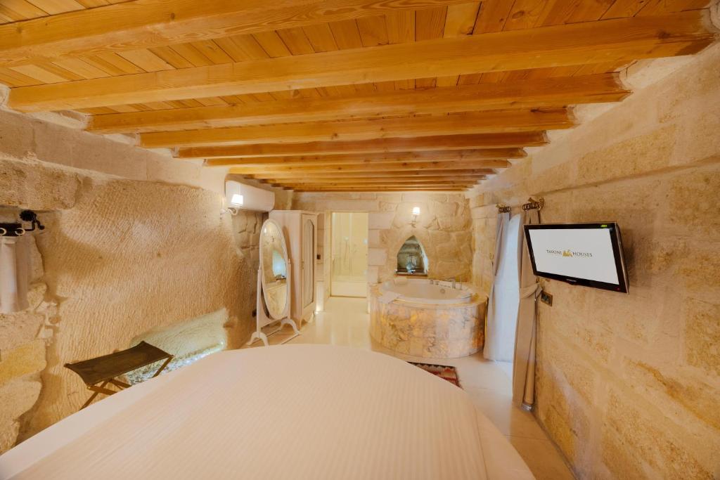 A bed or beds in a room at Tafoni Houses Cave Hotel
