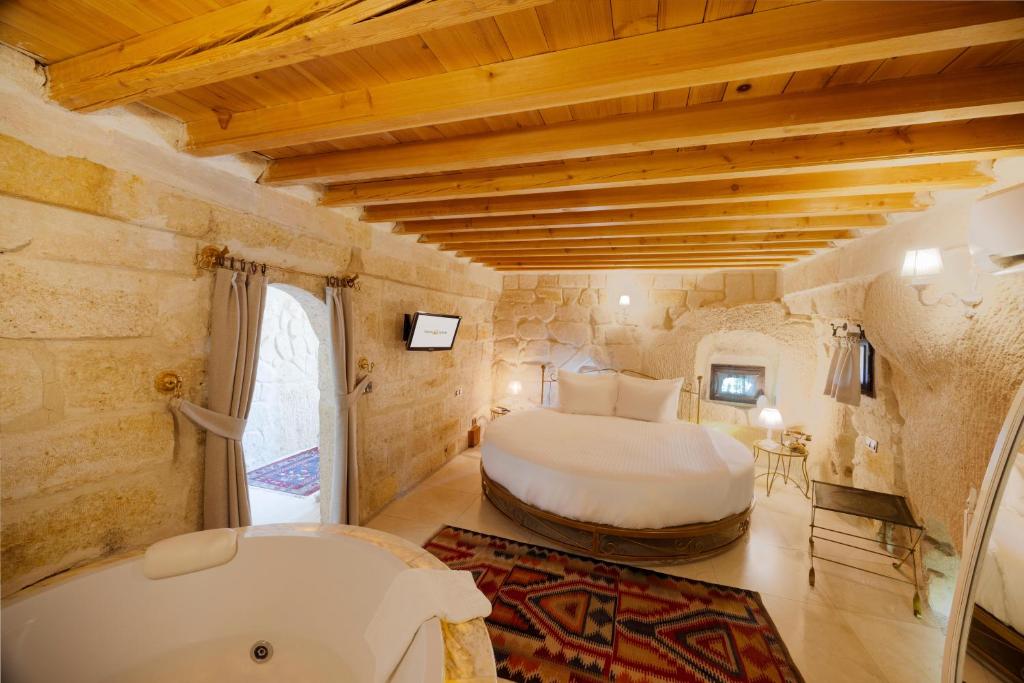A bed or beds in a room at Tafoni Houses Cave Hotel