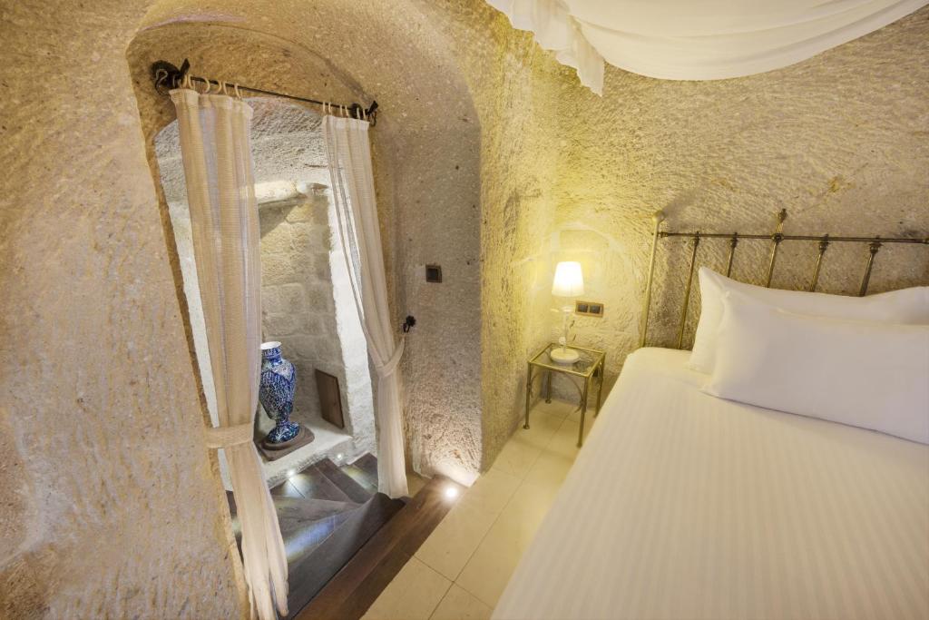 A bed or beds in a room at Tafoni Houses Cave Hotel