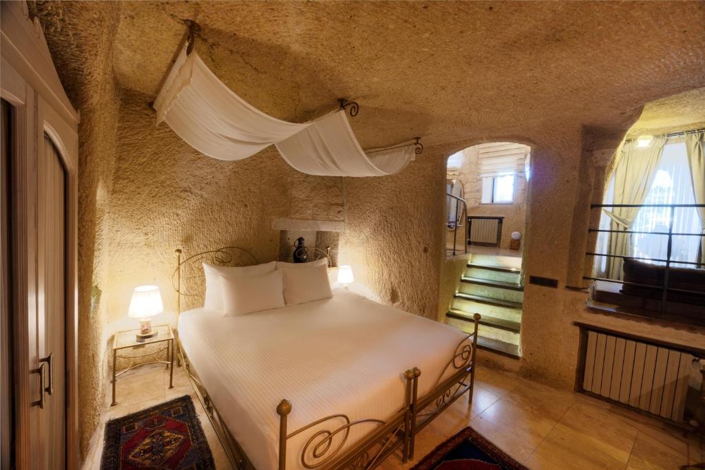 A bed or beds in a room at Tafoni Houses Cave Hotel
