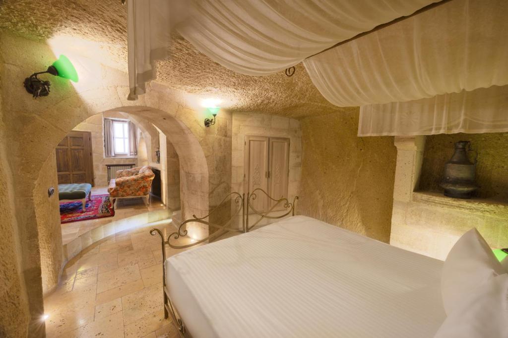 A bed or beds in a room at Tafoni Houses Cave Hotel