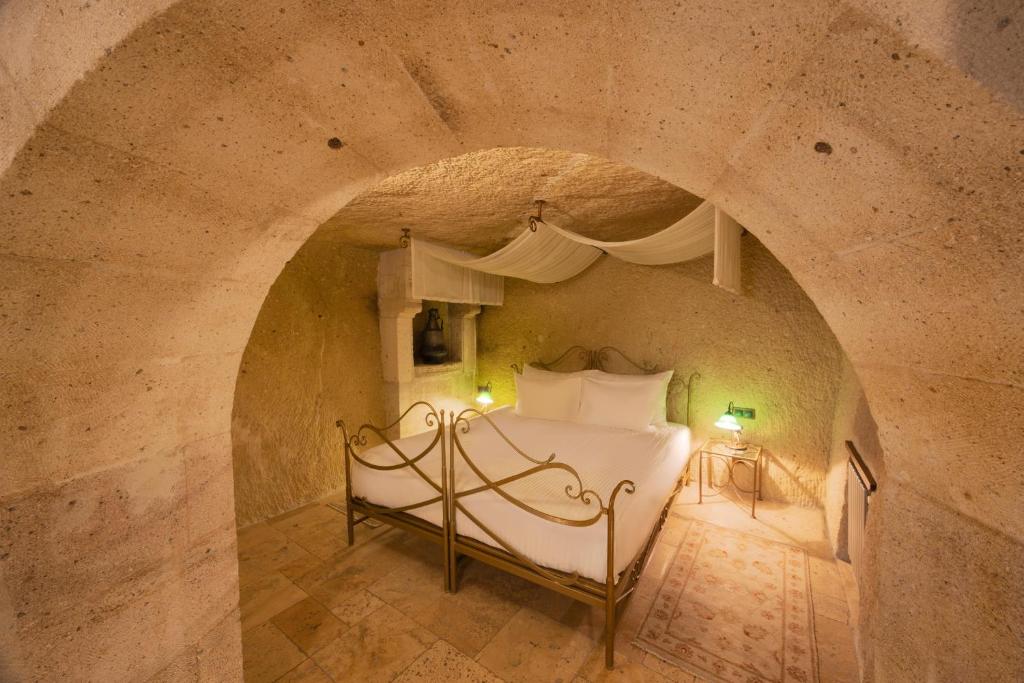 A bed or beds in a room at Tafoni Houses Cave Hotel