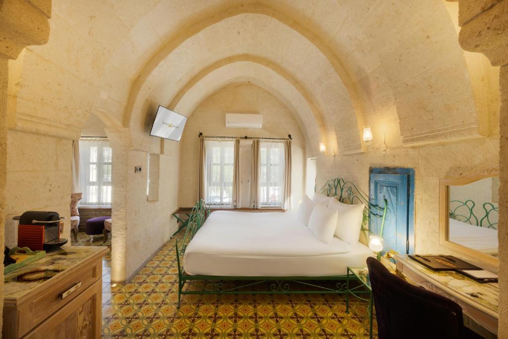 A bed or beds in a room at Tafoni Houses Cave Hotel