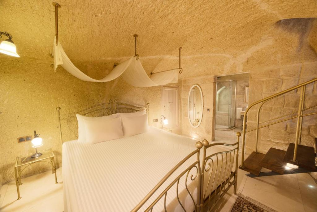 A bed or beds in a room at Tafoni Houses Cave Hotel