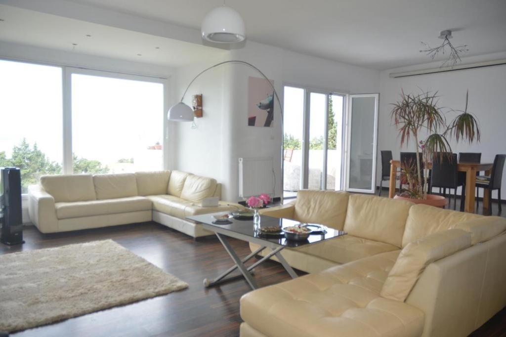 a living room with a couch and a table at Caecilia & Lawrence Villa in Chalkida