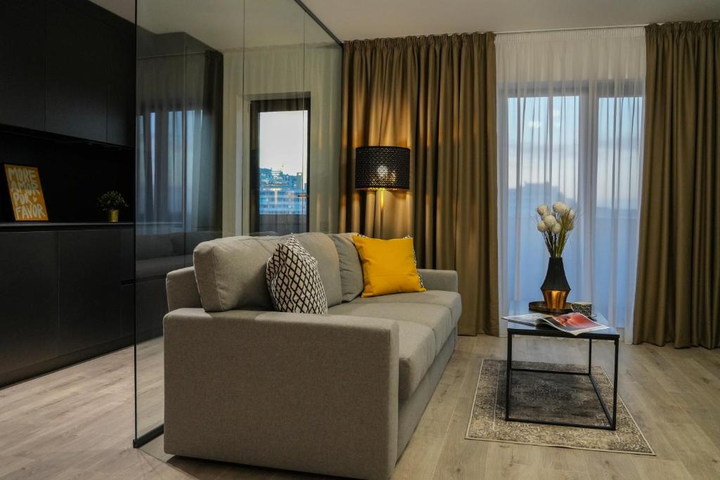 a living room with a couch and a table at Luca - Luxury Park-View Apt with Balcony in Bucharest