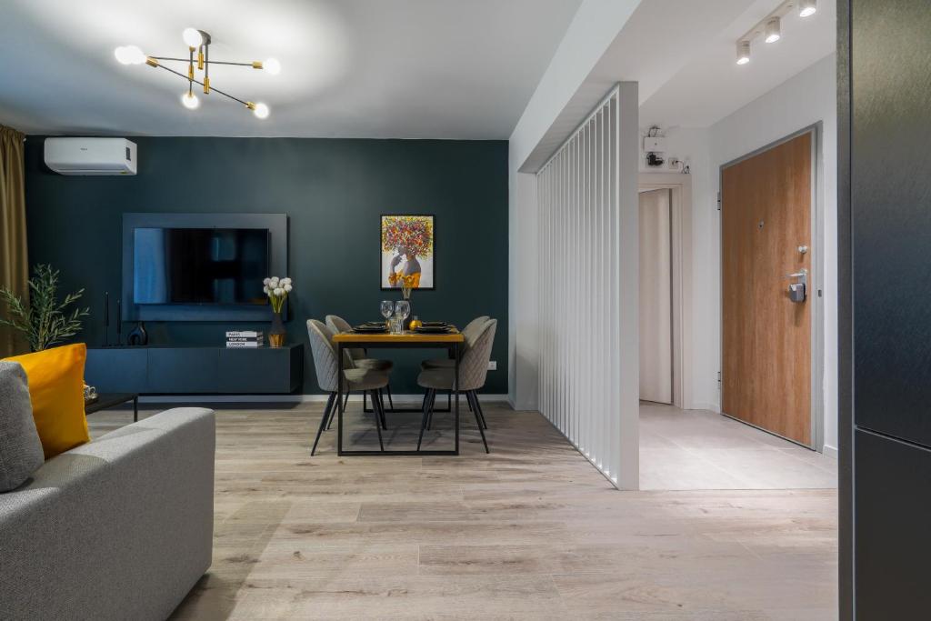 a living room with a table and chairs at Luca - Luxury Park-View Apt with Balcony & Parking in Bucharest