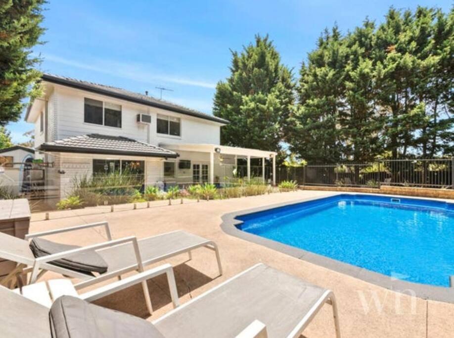 a swimming pool in the backyard of a house at SERENITY STAYS Mount Martha Mornington Peninsula in Mount Martha