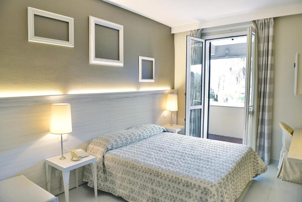 Postel nebo postele na pokoji v ubytování Hotel Degli Ulivi