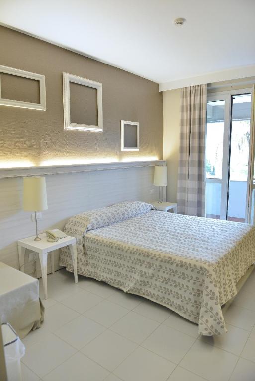 Postel nebo postele na pokoji v ubytování Hotel Degli Ulivi