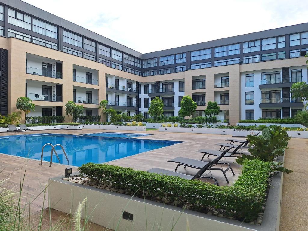 an exterior view of a building with a swimming pool at Embassy Garden Luxury in Accra