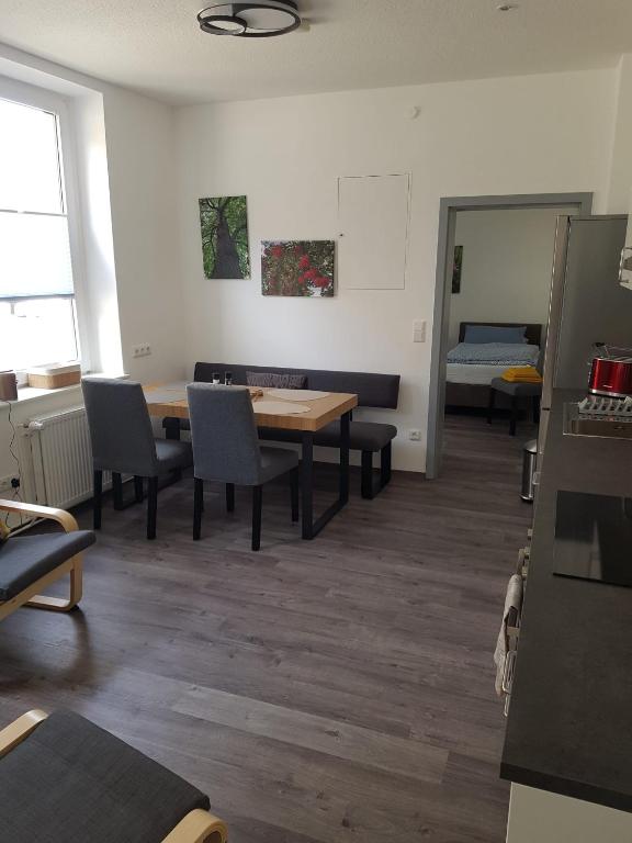 a dining room with a table and chairs at Gästehaus Harzstraße in Schladen