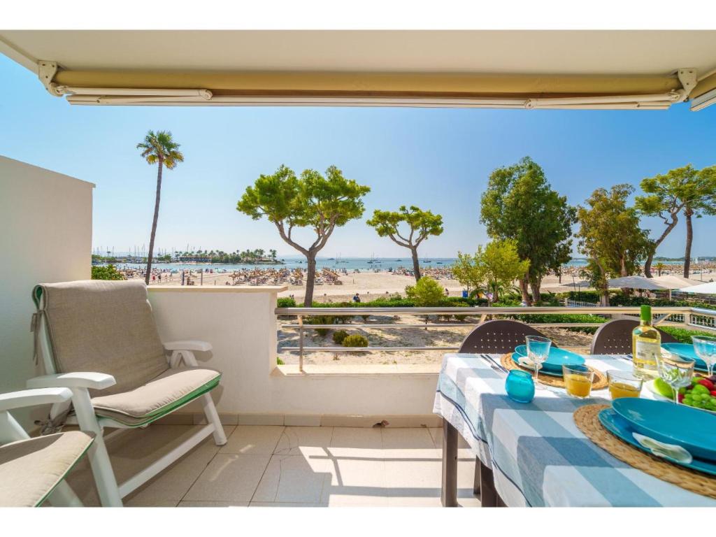 a balcony with a table and chairs and a view of the beach at Apartment Xisca by Interhome in Port d'Alcudia