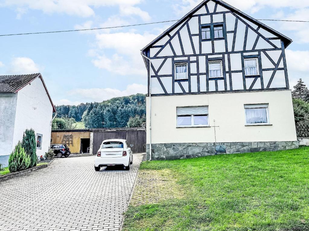 a white car parked in front of a house at Holiday Home Ferienhaus Renata nahe Nürburgring by Interhome in Quiddelbach