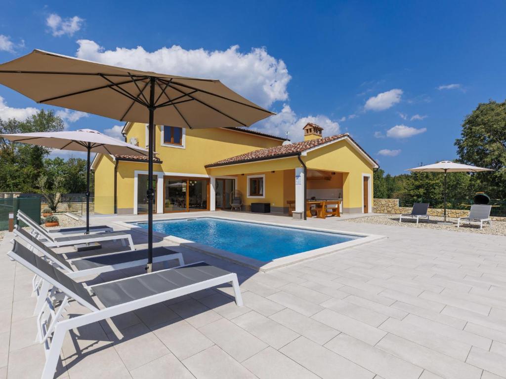 a villa with a swimming pool and a house at Holiday Home Villa Ana Lucija by Interhome in Labin