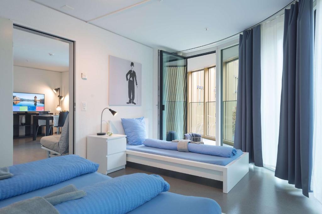 Postel nebo postele na pokoji v ubytování HITrental Allmend Comfort Apartments
