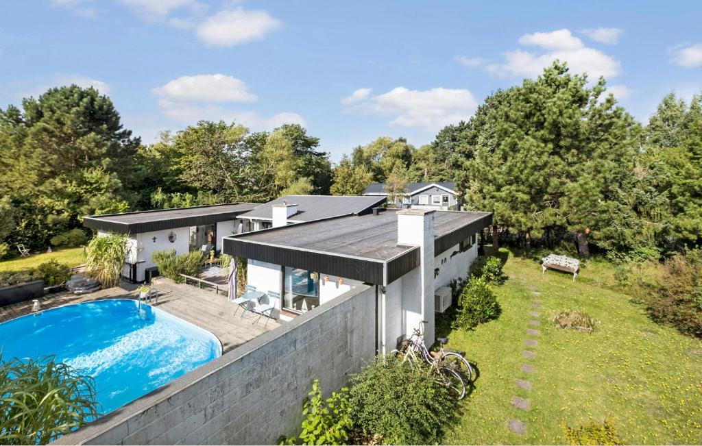 an aerial view of a house with a swimming pool at Amazing Home In Sjællands Odde in Yderby