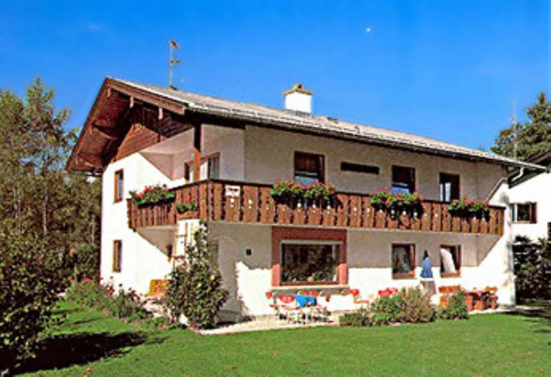 a large house with a balcony with flowers on it at Haus Auzinger in Schönau am Königssee