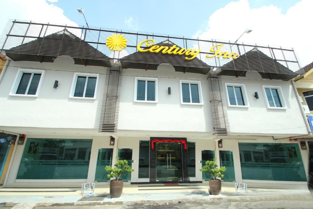 a building with a sign on top of it at Century Inn Hotel in Cukai