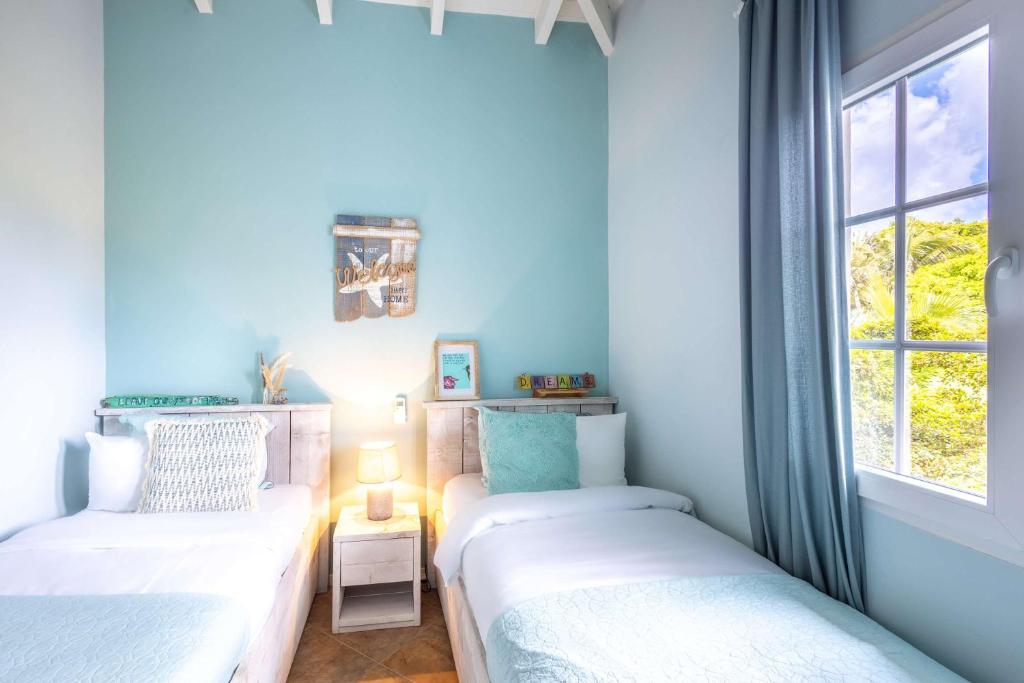 Postel nebo postele na pokoji v ubytování MasBango Luxury Penthouse at Jan Thiel