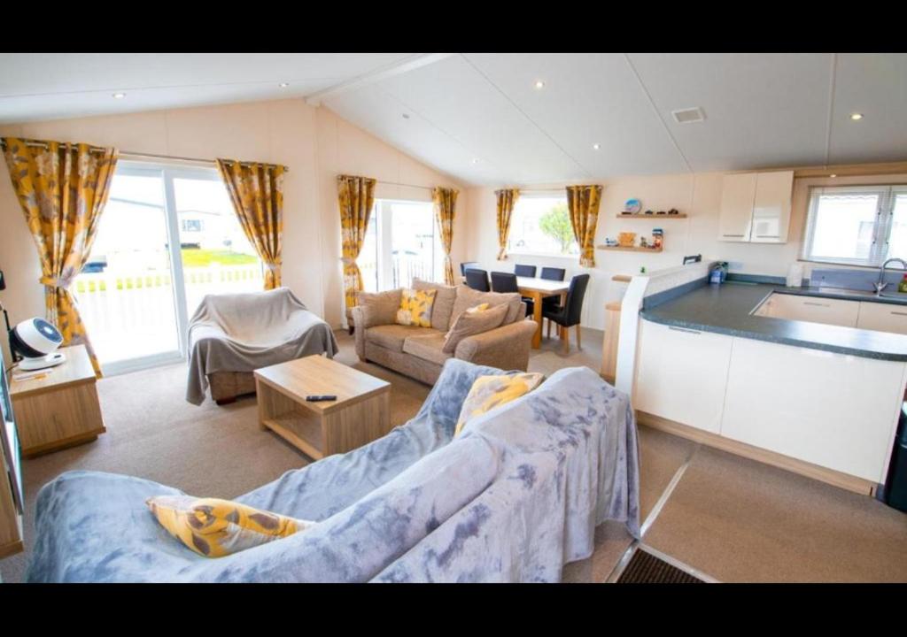 a large living room with a couch and a kitchen at MP629 Parkdean Camber Sands in Camber