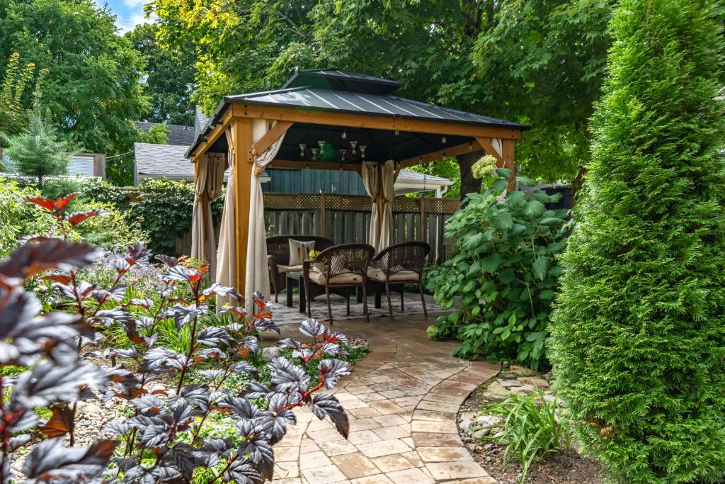 a gazebo with a table and chairs in a garden at The 1885 Suites in Picton