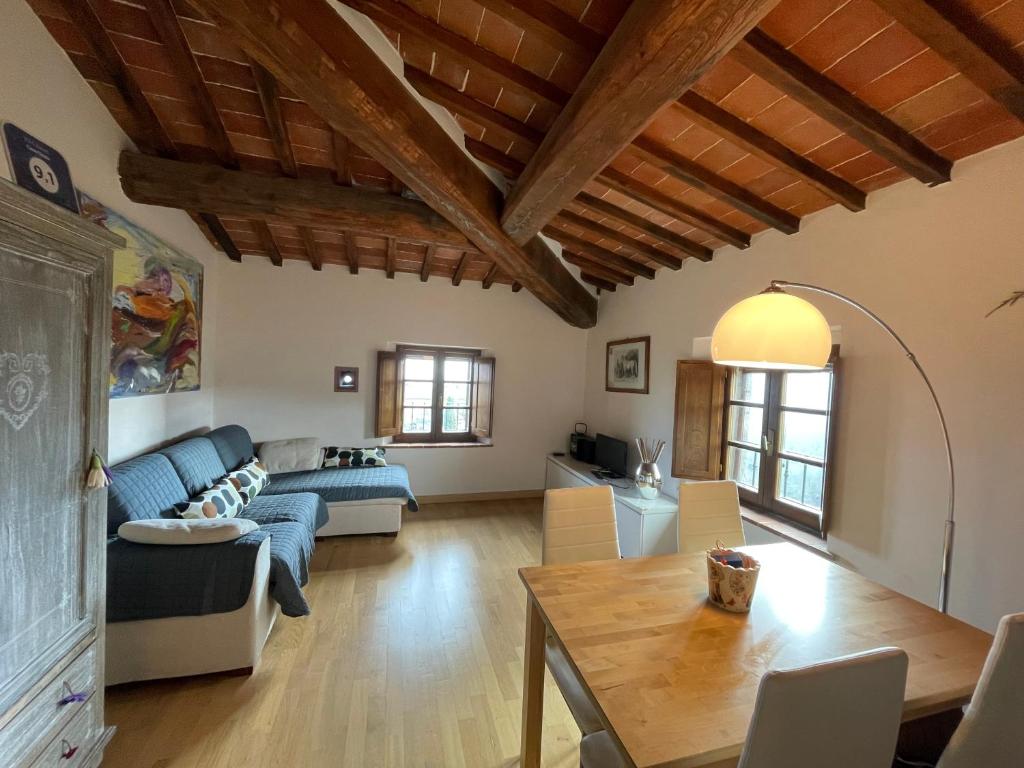 a living room with a blue couch and a table at Oasi nel Chianti in Località Tregole in Castellina in Chianti