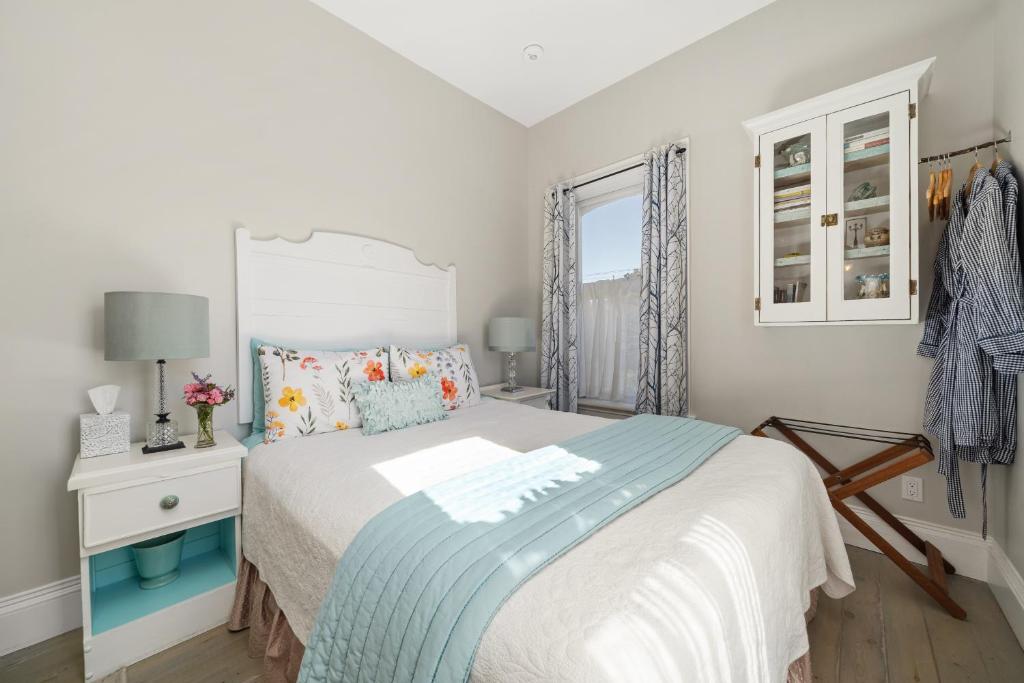 a bedroom with a bed and a window at The 1885 Suites in Picton