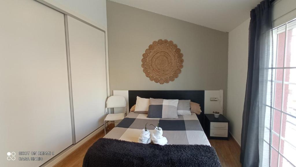 a bedroom with a bed with two white shoes on it at Apartamento 2 habitaciones ZEN in Deltebre