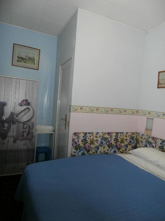Postel nebo postele na pokoji v ubytování Albergo Junior