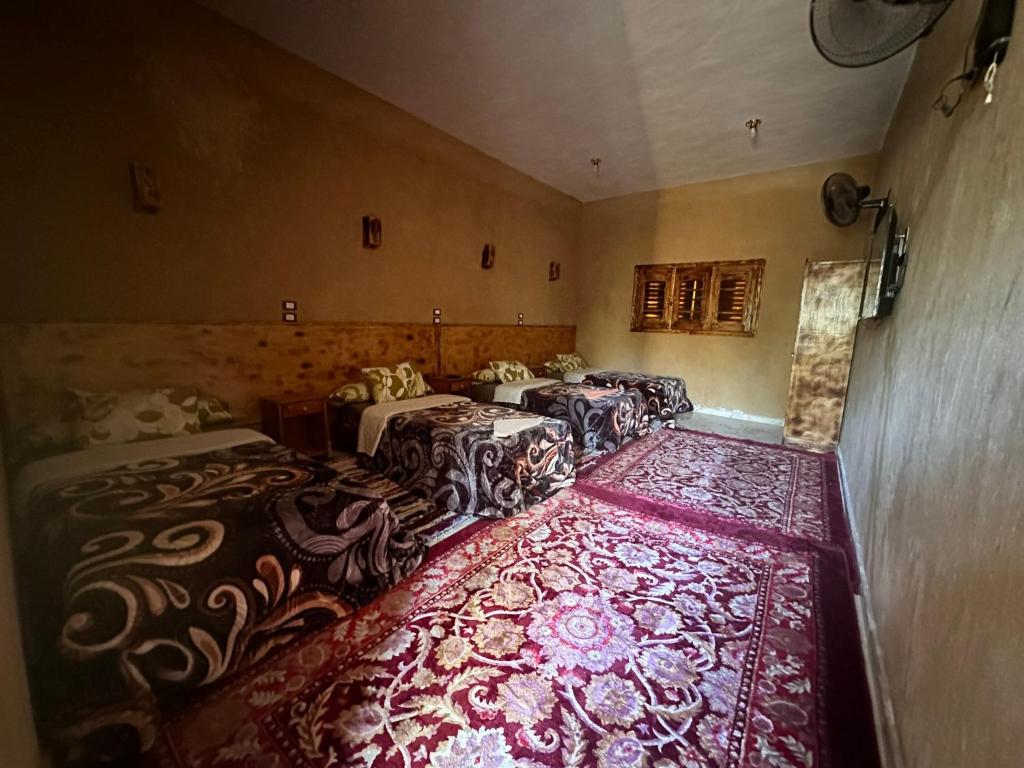 Postel nebo postele na pokoji v ubytování Nour El Waha Hotel
