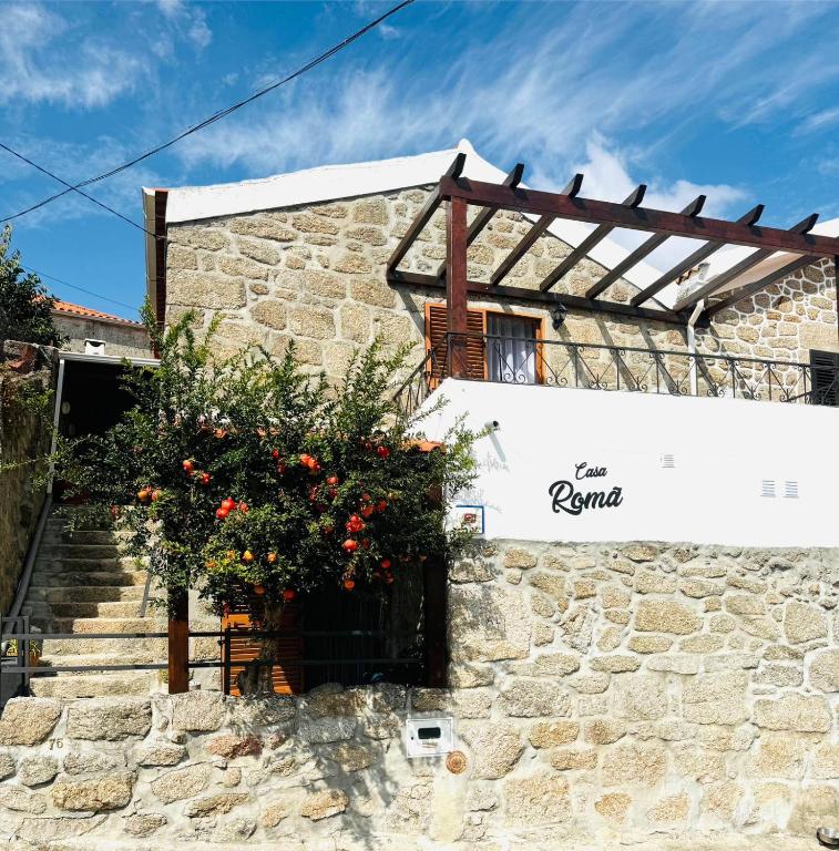 a building with flowers on the side of it at Casa Romã in Vale de Azares