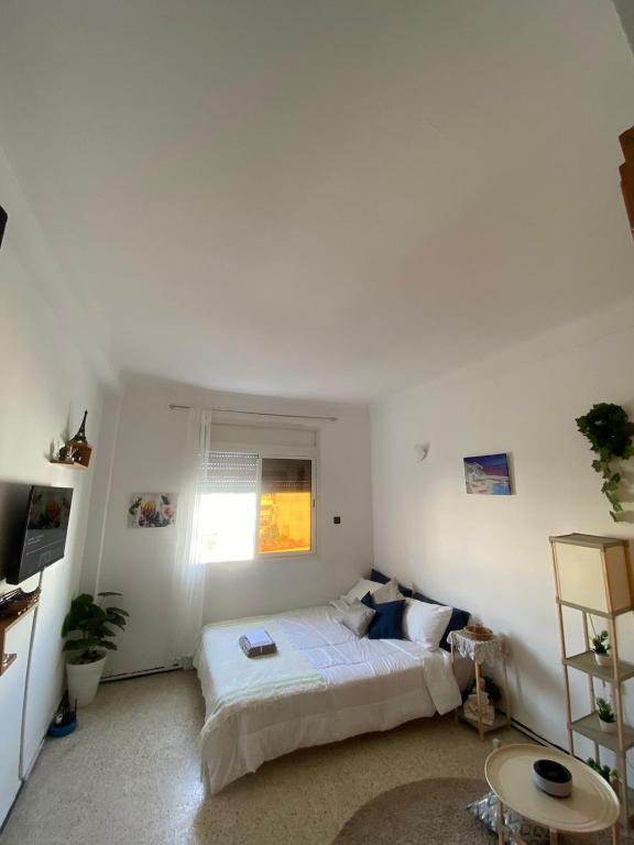 Ένα ή περισσότερα κρεβάτια σε δωμάτιο στο Chambre d'hôte dans un appartement