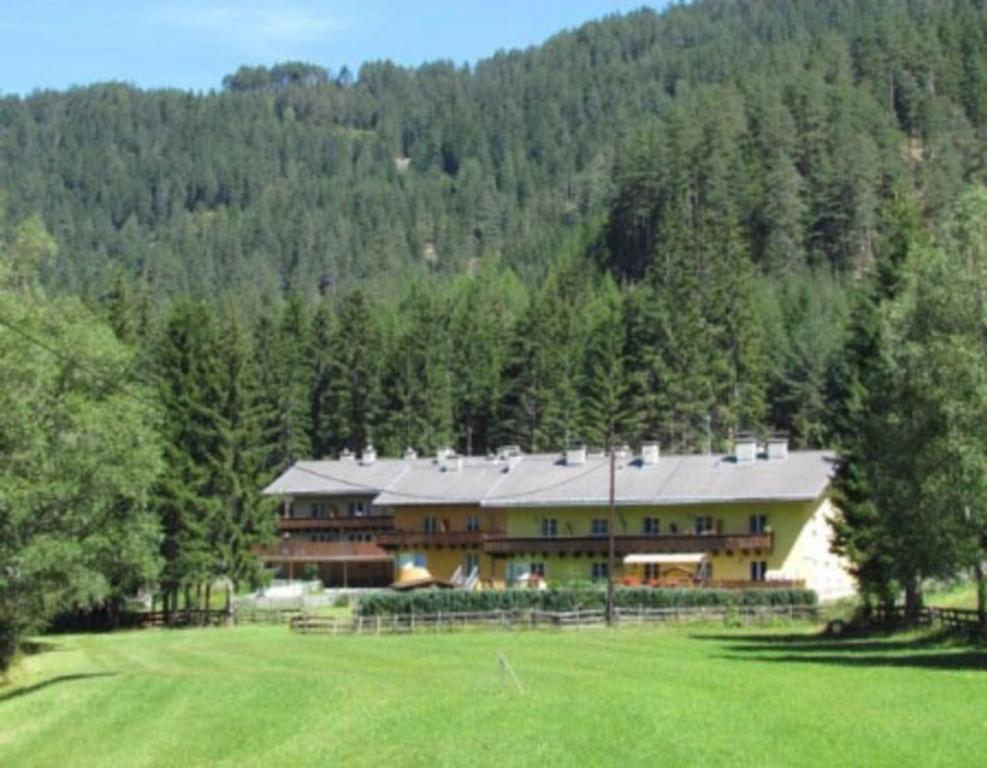 a large house in the middle of a field at Ferienwohnung Bernhardiner in Nauders