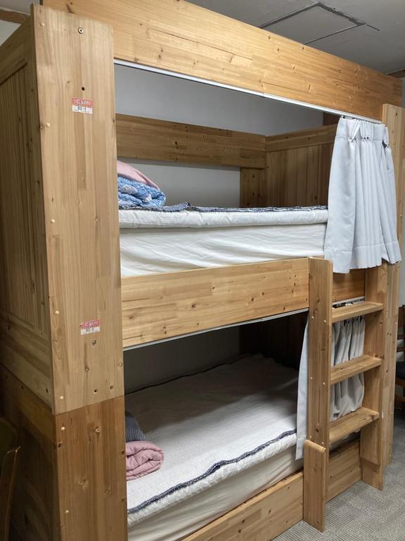 a wooden bunk bed in a room at The Core Albergue in Seoul