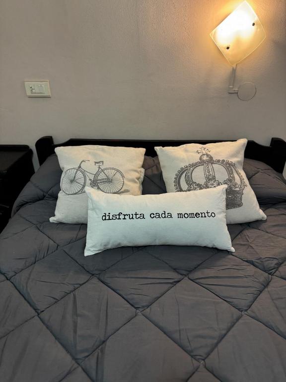 a bed with pillows with a bicycle on it at HColon in Colón