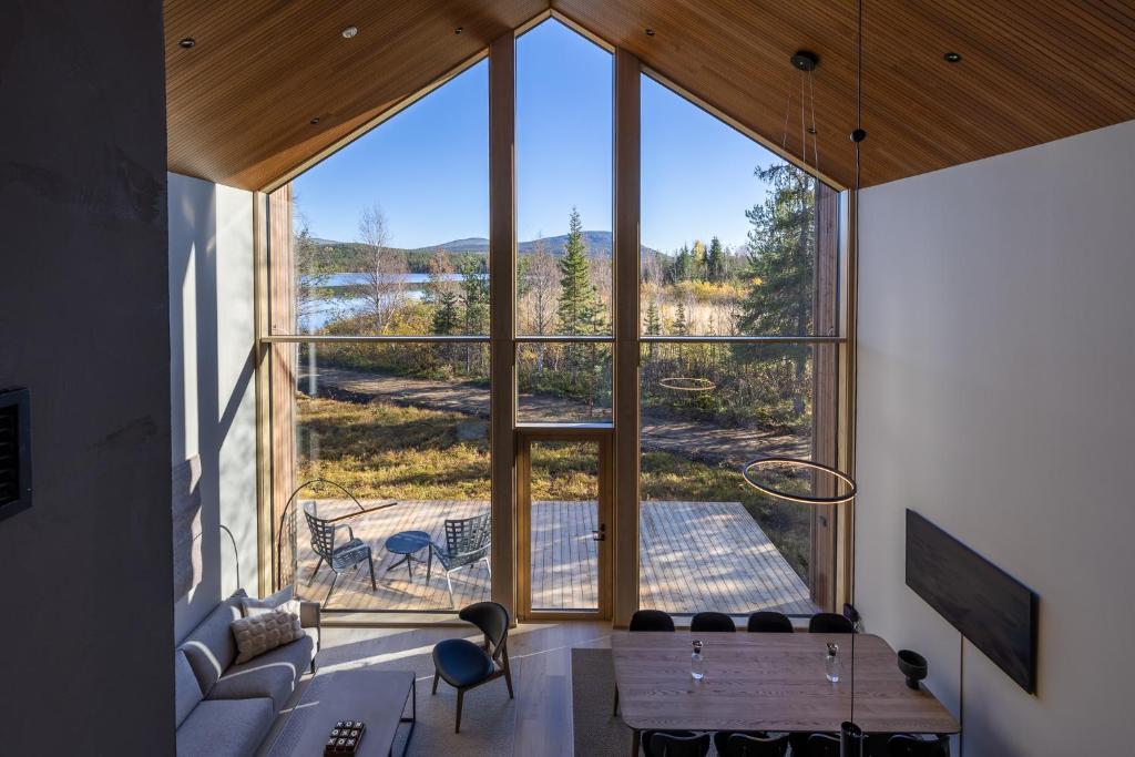 a large window in a living room with a view at Joikun Lumo by Hi Ylläs in Äkäslompolo