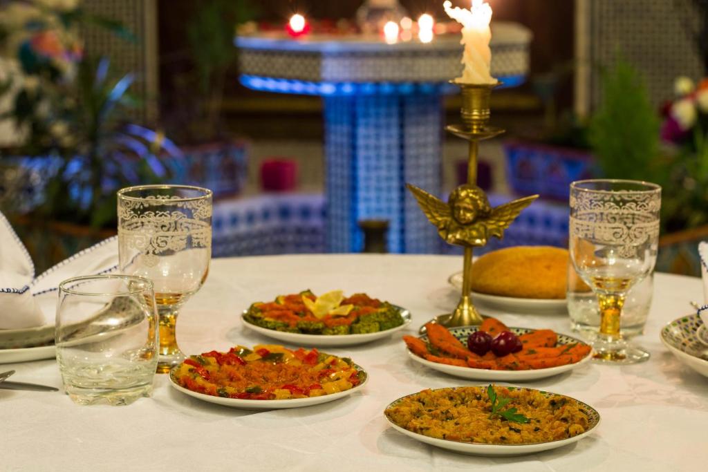 a table with plates of food on a table at Riad Fes Kettani in Fez