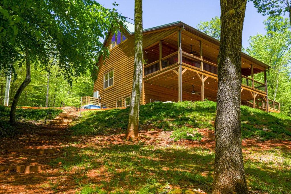 a large wooden house in the woods with trees at Foothills Family Retreat - 7 Bedrooms, Hot Tub in Cleveland