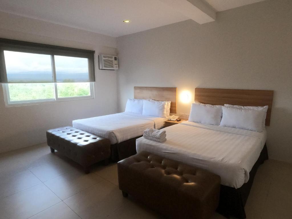Postel nebo postele na pokoji v ubytování Mango Suites