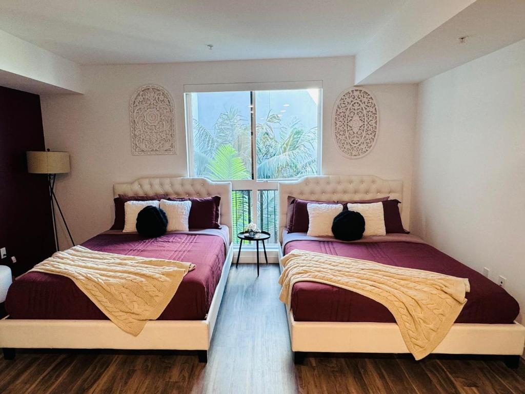 una camera da letto con due letti e una finestra di Spectacular Cozy loft Hollywood FREE Parking a Los Angeles