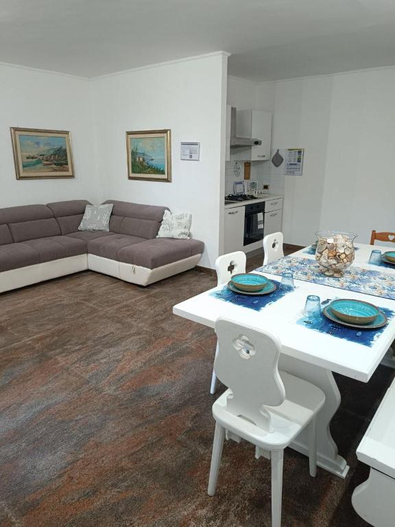 a living room with a couch and a table and chairs at Regina sul Mare in Terracina