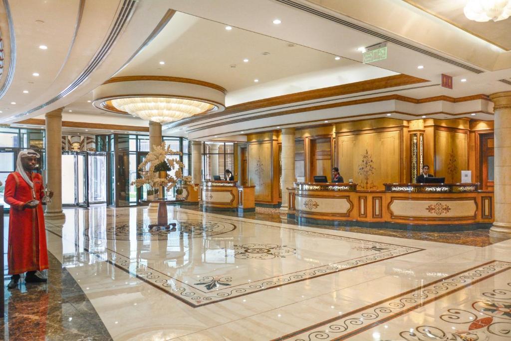 a woman standing in a lobby of a building at Crowne Plaza Bahrain by IHG in Manama