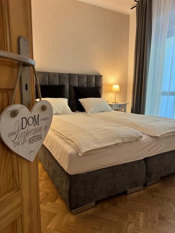 a bedroom with a bed with a heart sign on it at Juli Apart in Kraków